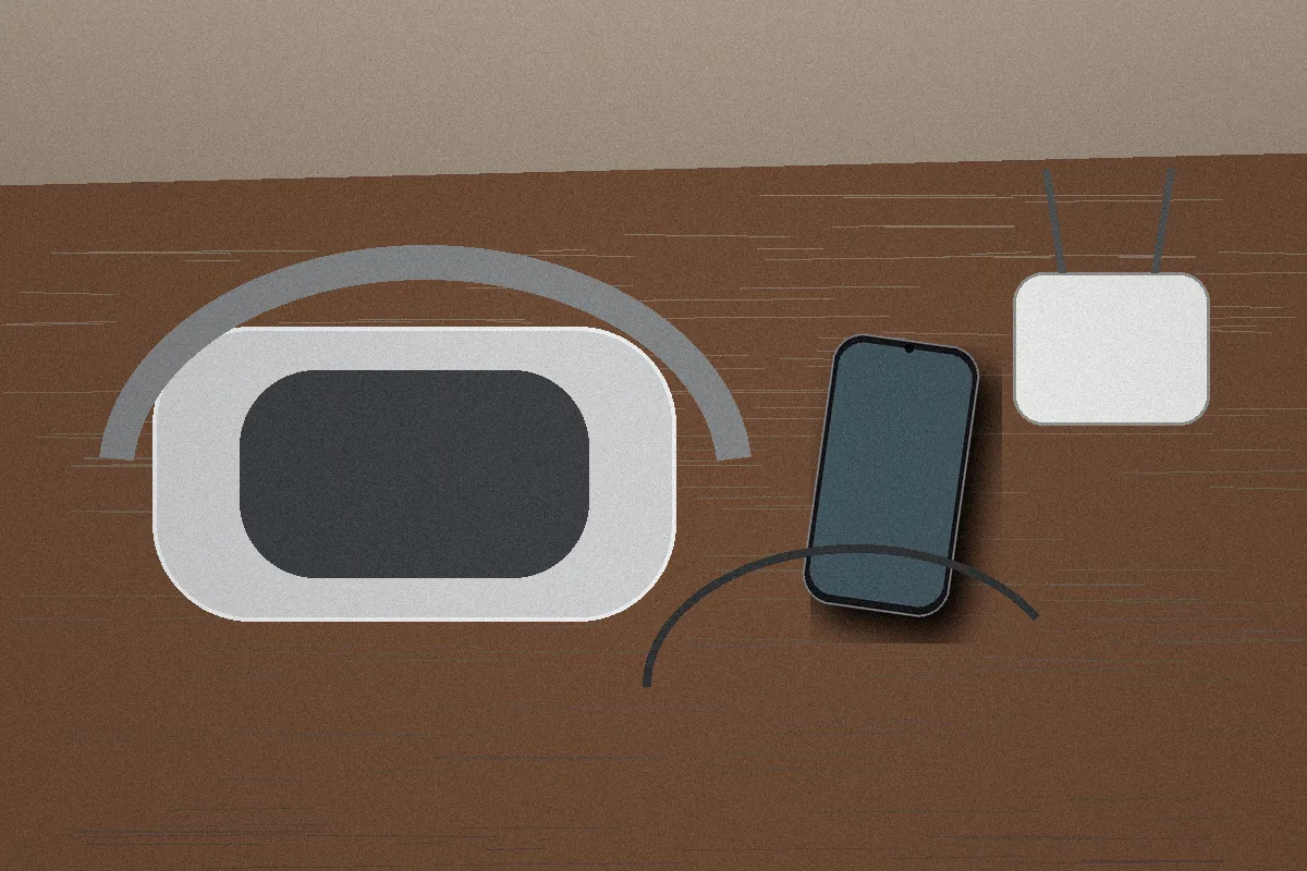 Apple Vision Pro resting beside a phone hotspot and hotel network equipment