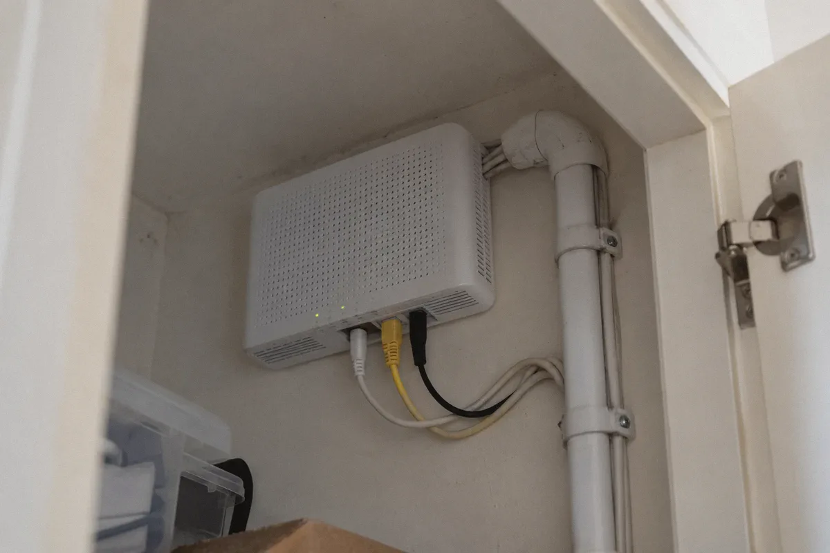 An ISP-managed modem inside a utility cupboard.