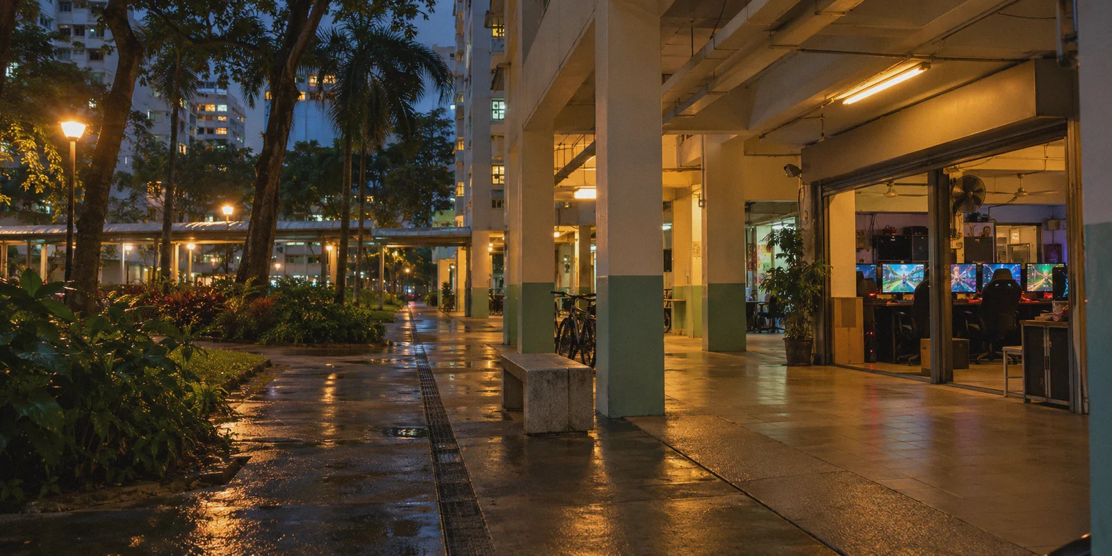 An evening gaming shop beneath Singapore housing blocks.