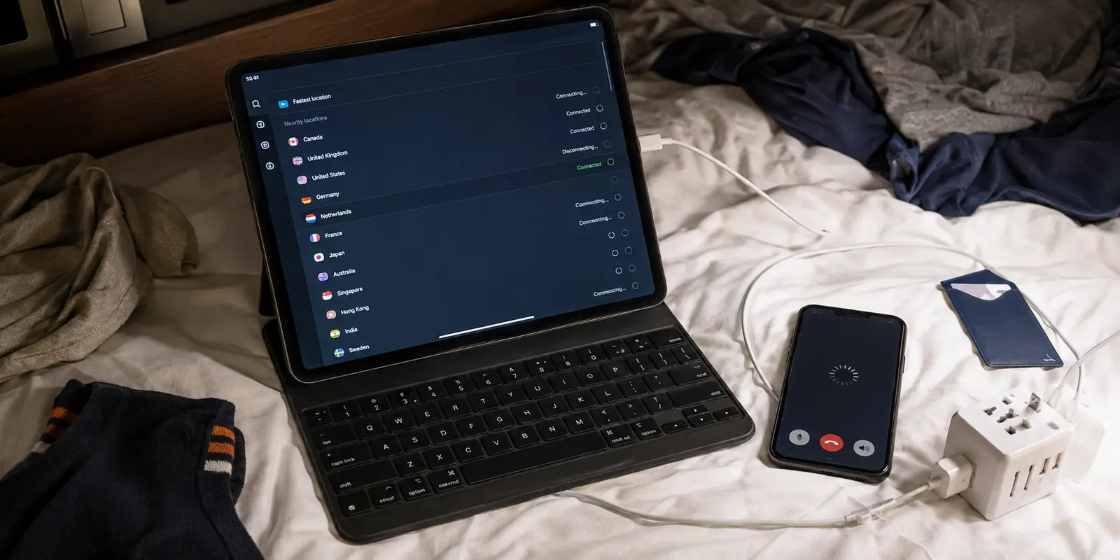 A travel tablet and phone on a rumpled Dubai hotel bed during repeated VPN connection attempts