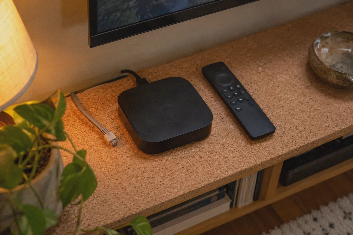Streaming hardware and its wired connection on a cork shelf.