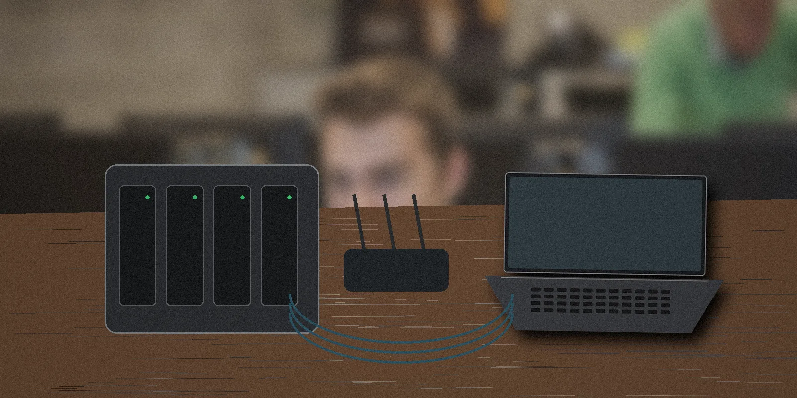 Four-bay home NAS connected to a router and laptop in a realistic home office