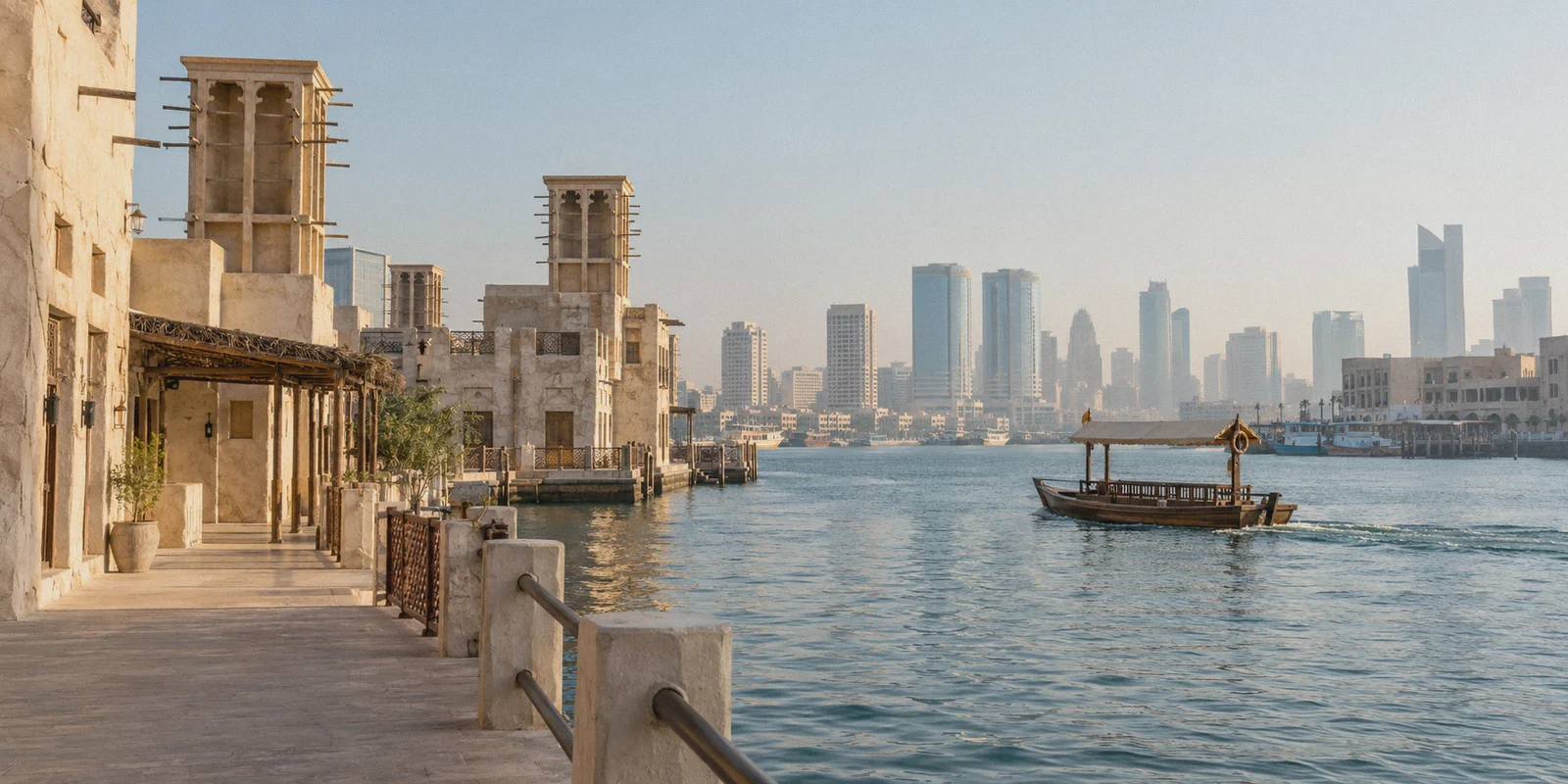 Dubai Creek and wind-tower buildings in morning light.