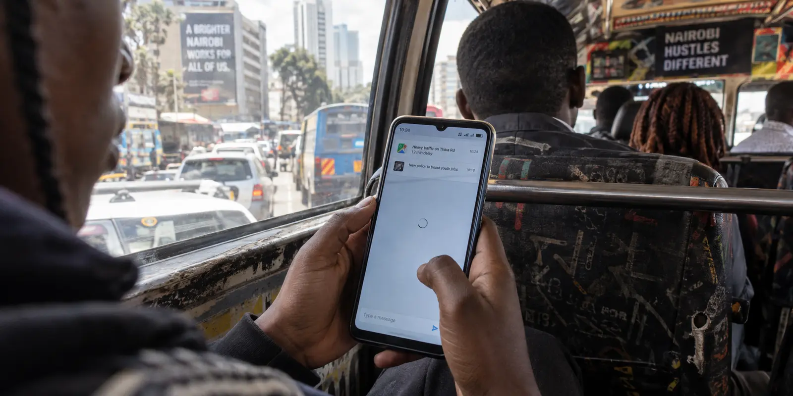 A messaging page stalls on a phone with strong mobile signal during a normal Nairobi matatu commute.