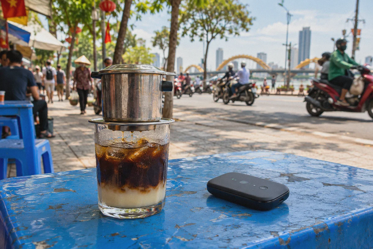 Vietnamese coffee and a mobile hotspot on a cafe table.