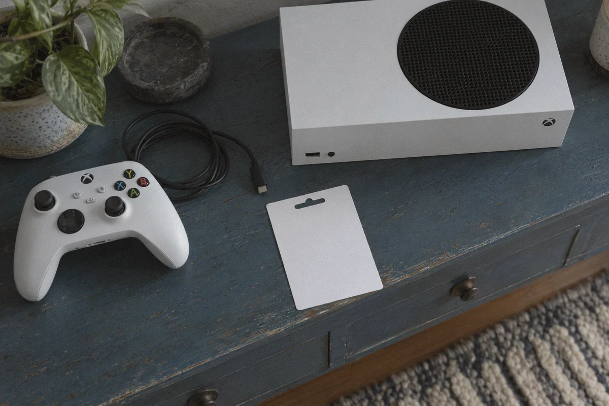 Prepaid gaming voucher beside a console.