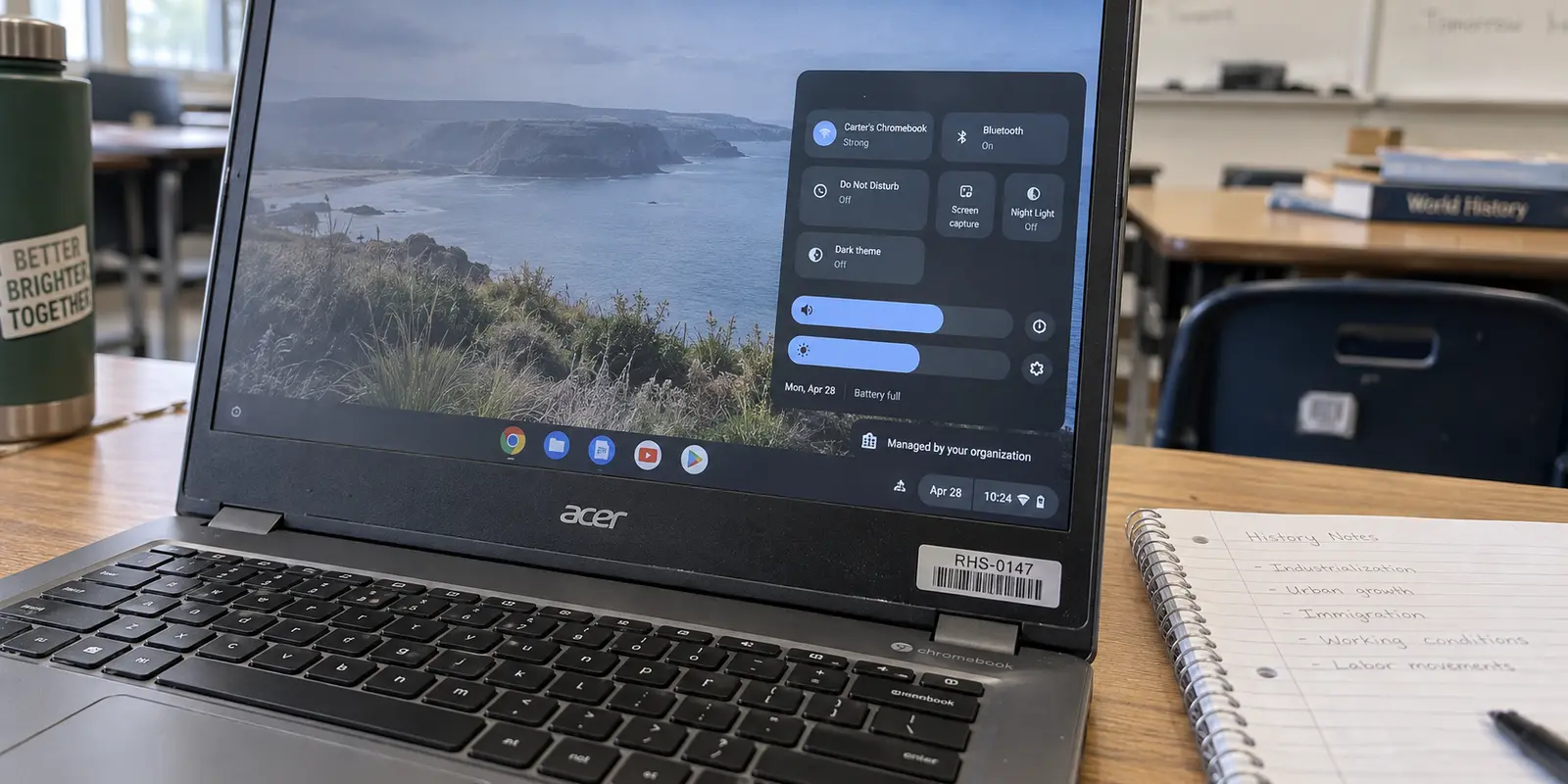 A school Chromebook shows the managed-by-your-organization status in ChromeOS quick settings