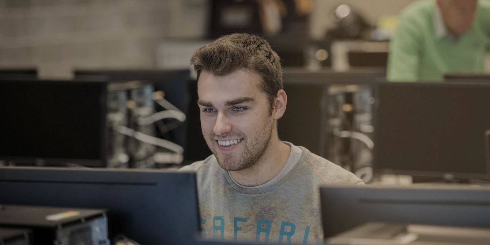 Person working at a computer in a shared study space.