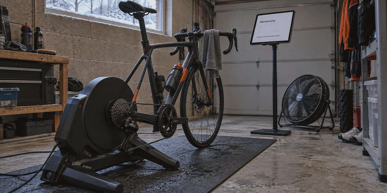 Indoor cycling trainer with a membership payment message on the tablet.