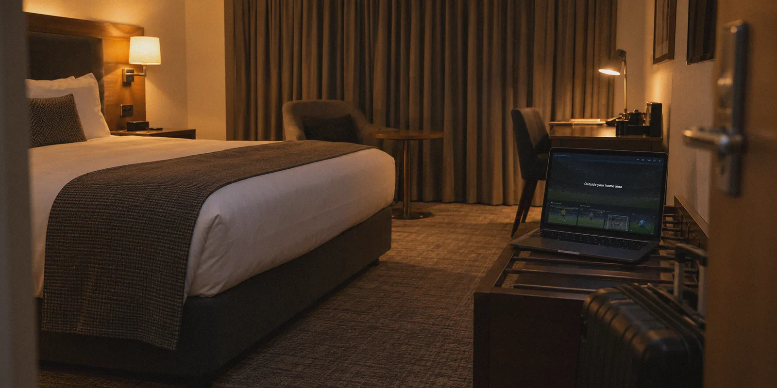 A hotel-room laptop showing an outside-home-area playback message.