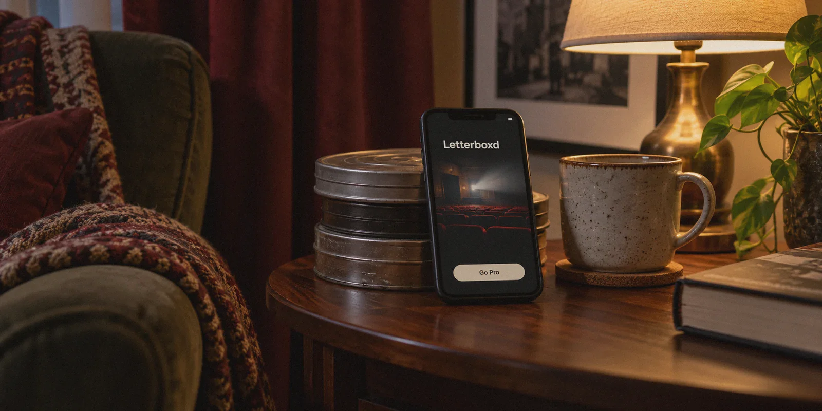 A phone displaying a Letterboxd upgrade page beside film discs.