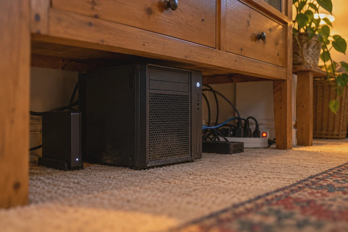 Home server and power strip under a sideboard.