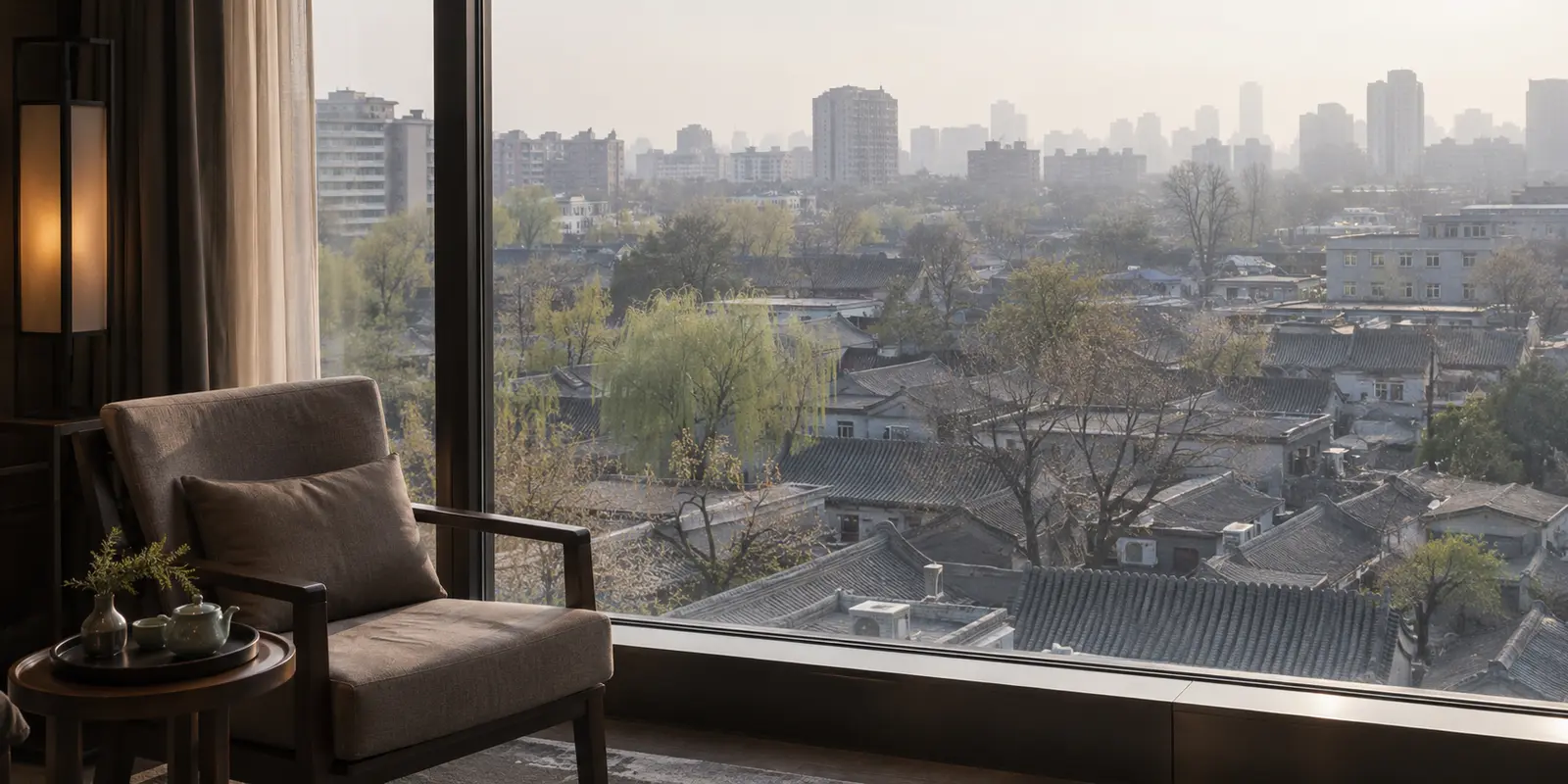 A Beijing hotel lounge overlooking hutong rooftops and the hazy city
