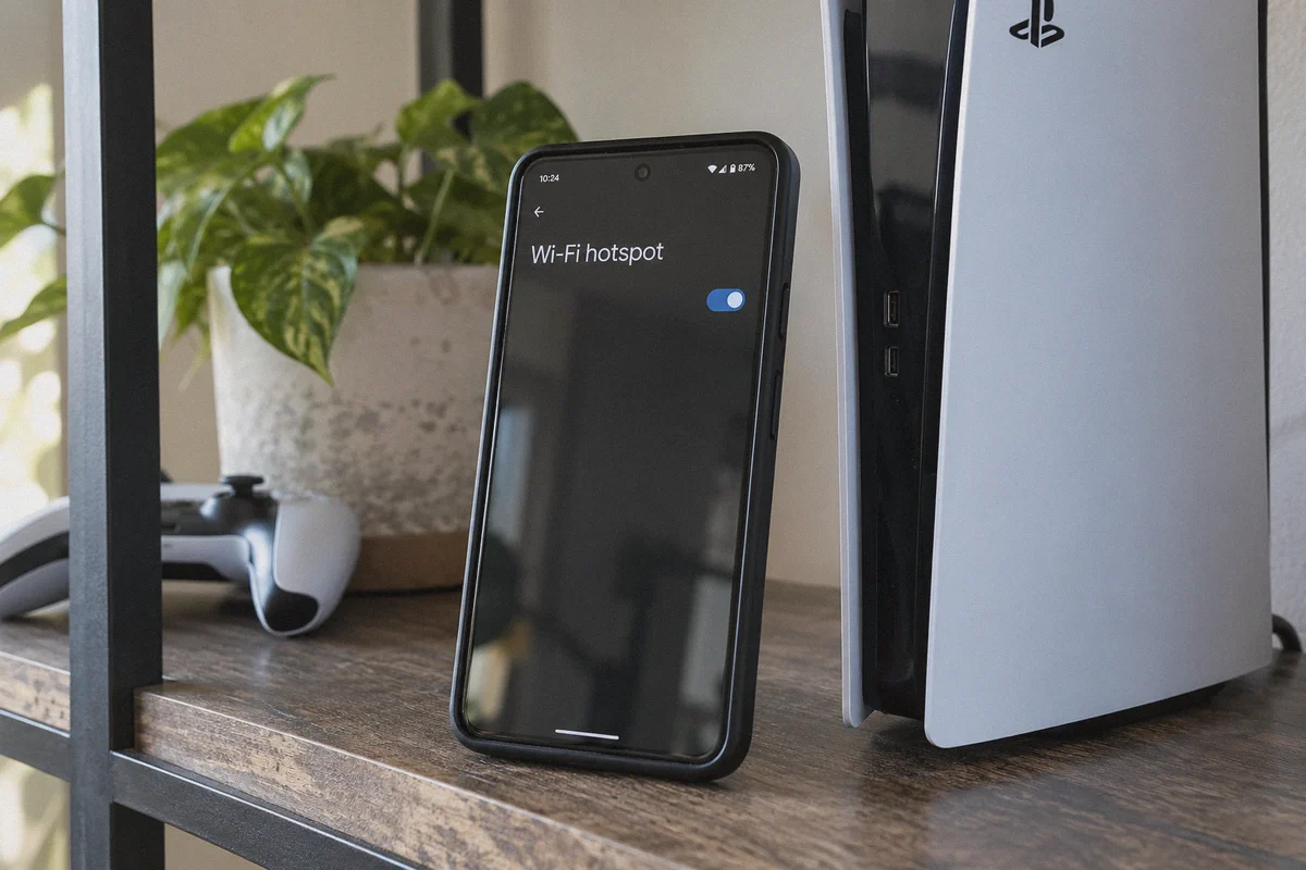 A phone’s Wi-Fi hotspot settings beside a console.