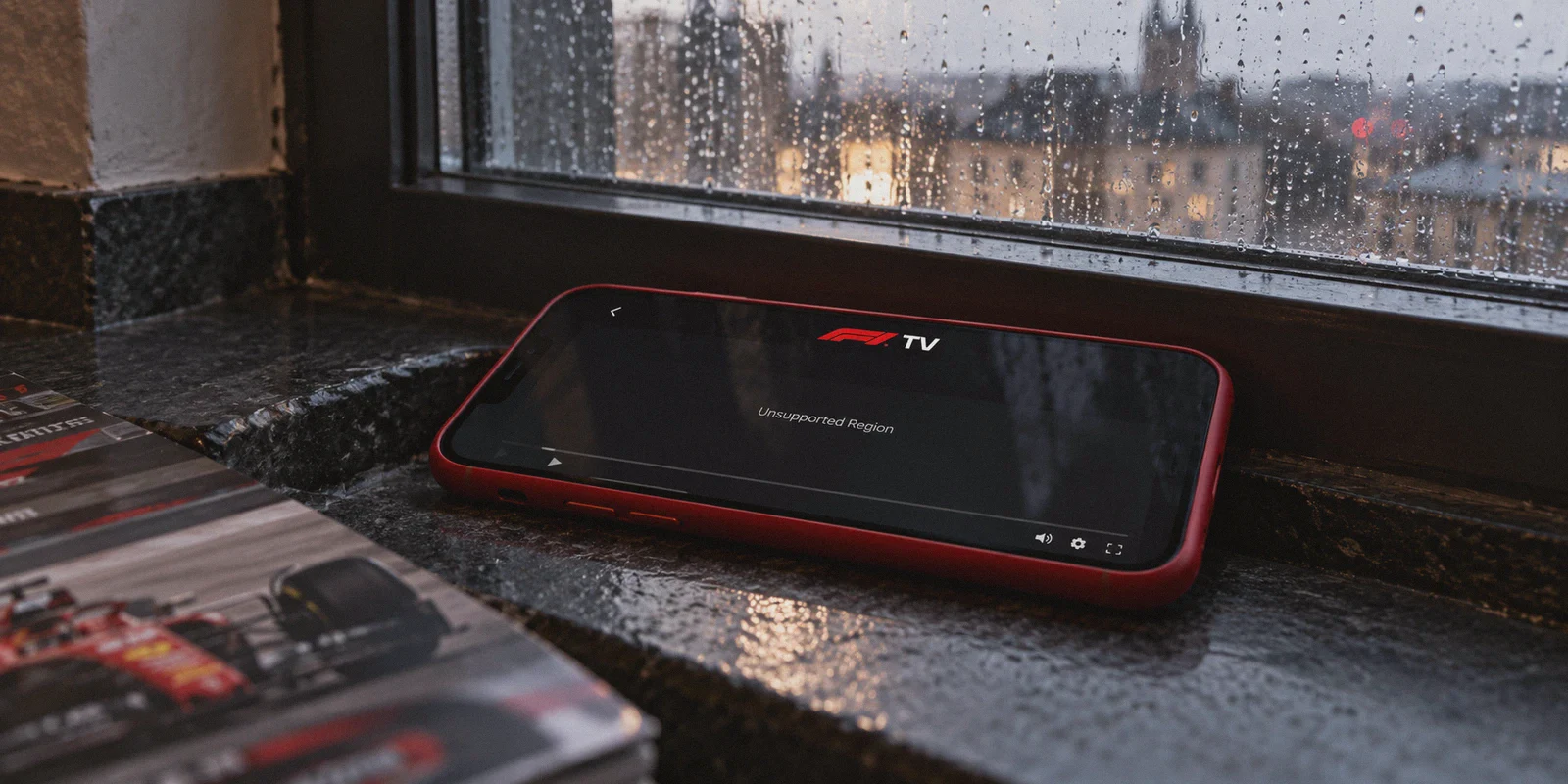 A phone showing an unsupported-region message in the F1 TV player.