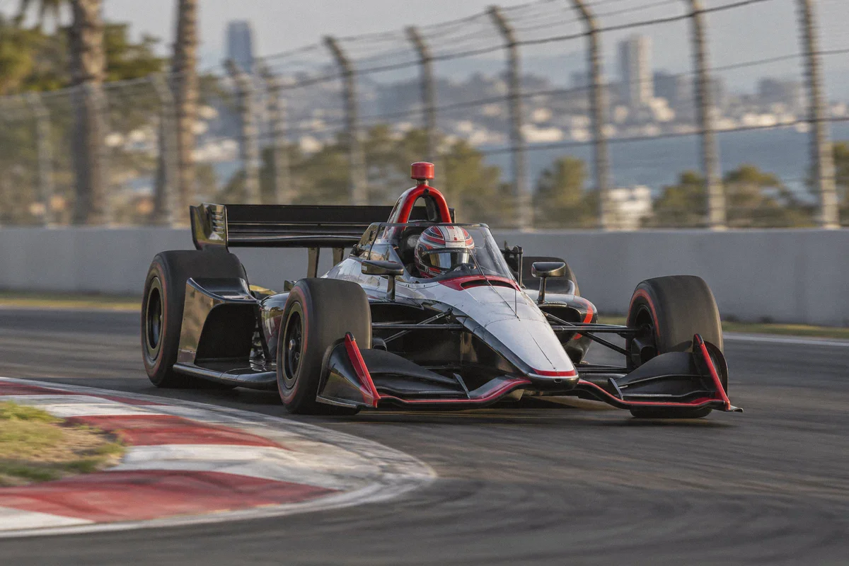 An open-wheel racing car taking a road-course corner.