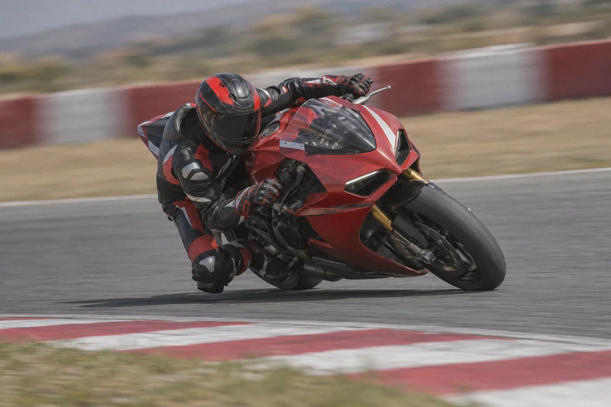 Motorcycle rider leaning through a racing corner.