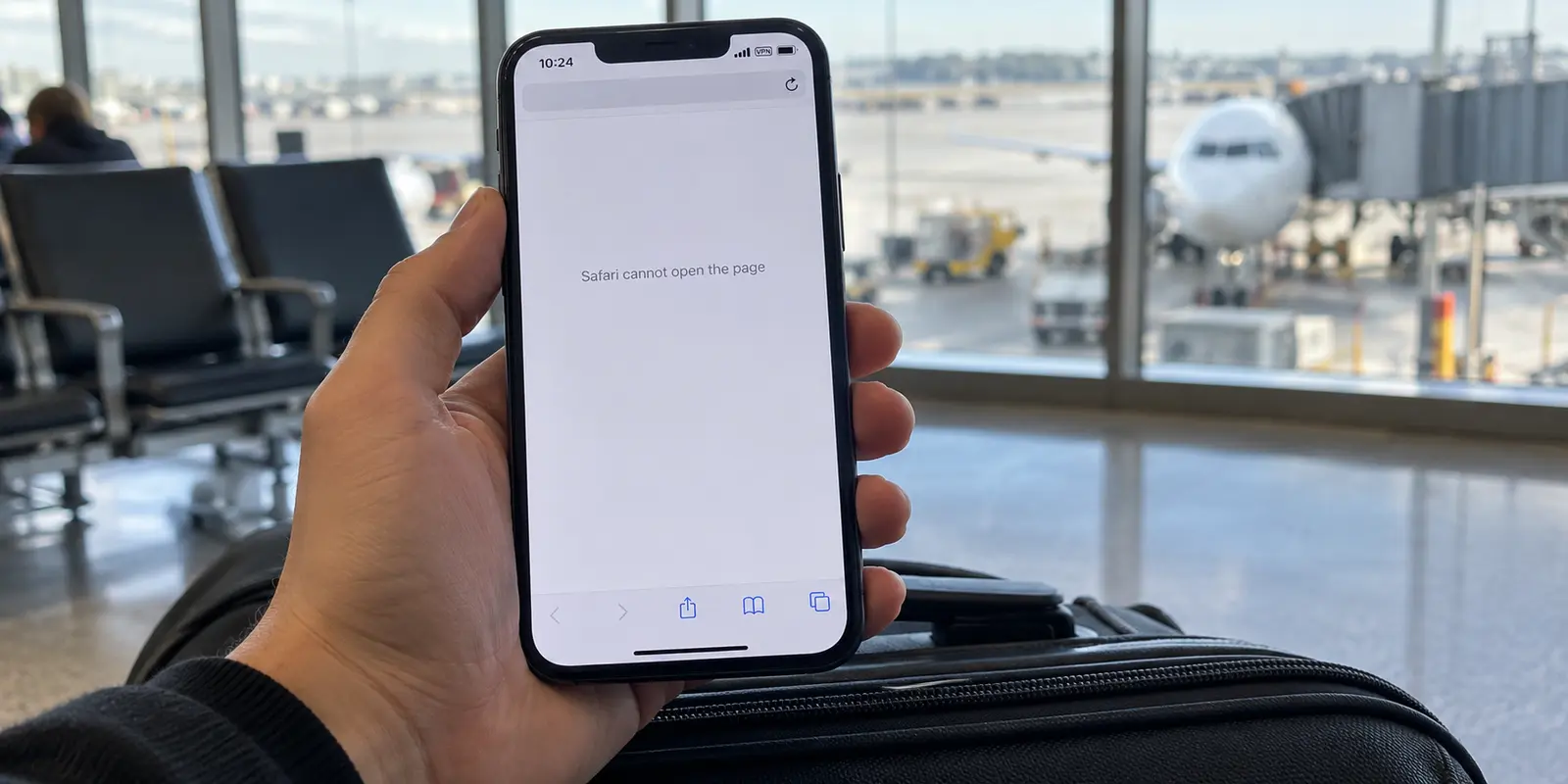 An iPhone at an airport showing an active VPN indicator while Safari cannot open the page