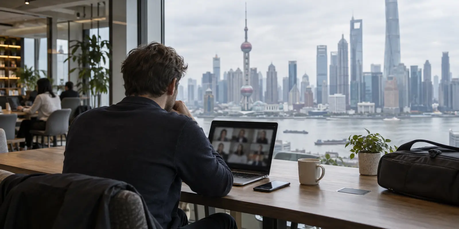 An overseas employee joining a work meeting from a Shanghai coworking lounge