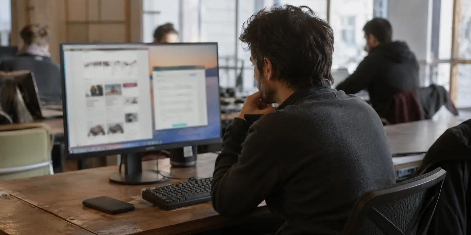 مستخدم يعمل بين نافذة متصفح وتطبيقات مستقلة في مساحة عمل مشتركة
