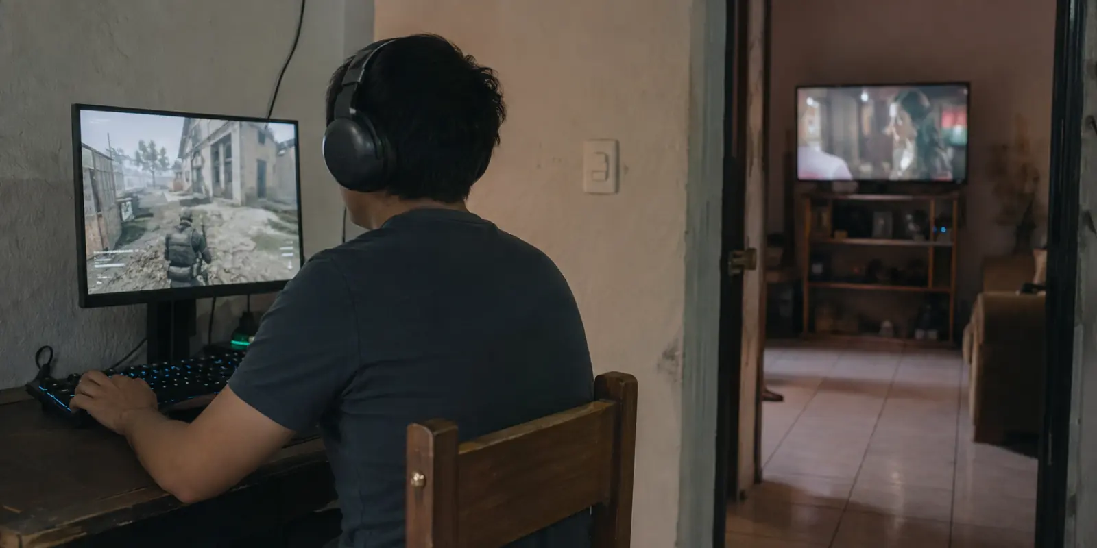 Un jugador en México juega en una computadora mientras otra pantalla transmite video en la habitación contigua