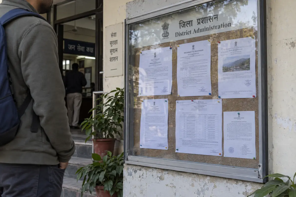 A traveler checking notices at an Indian district administration office