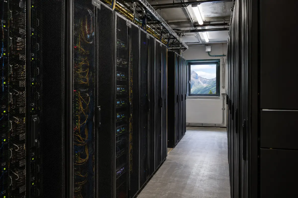 Serverracks in einem Schweizer Rechenzentrum mit Blick auf die Alpen
