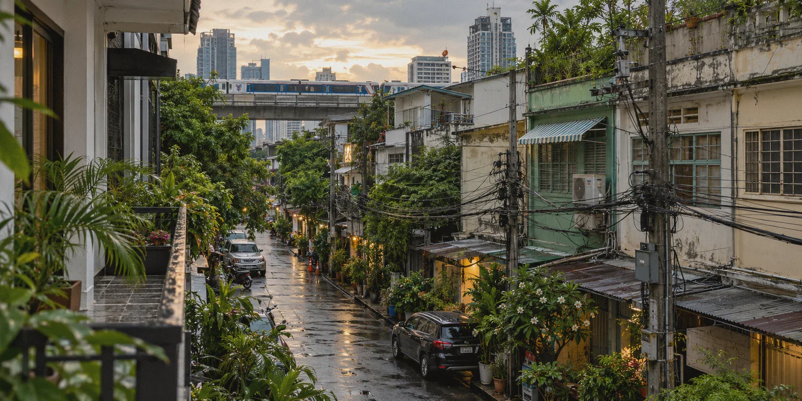 Bangkok shophouses and elevated railway beyond a hotel balcony.