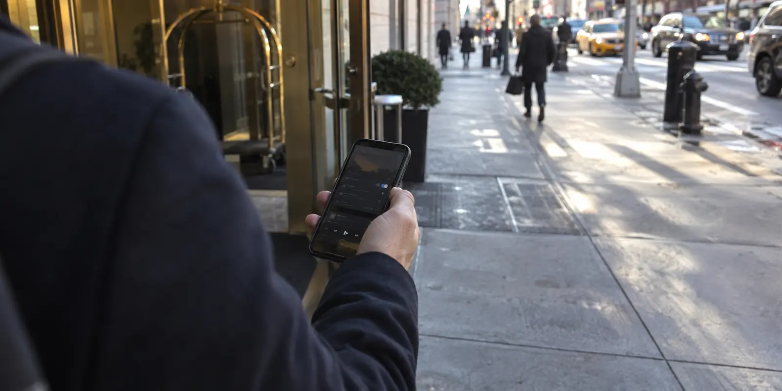 Traveler checking a phone as it changes from hotel Wi-Fi to cellular service
