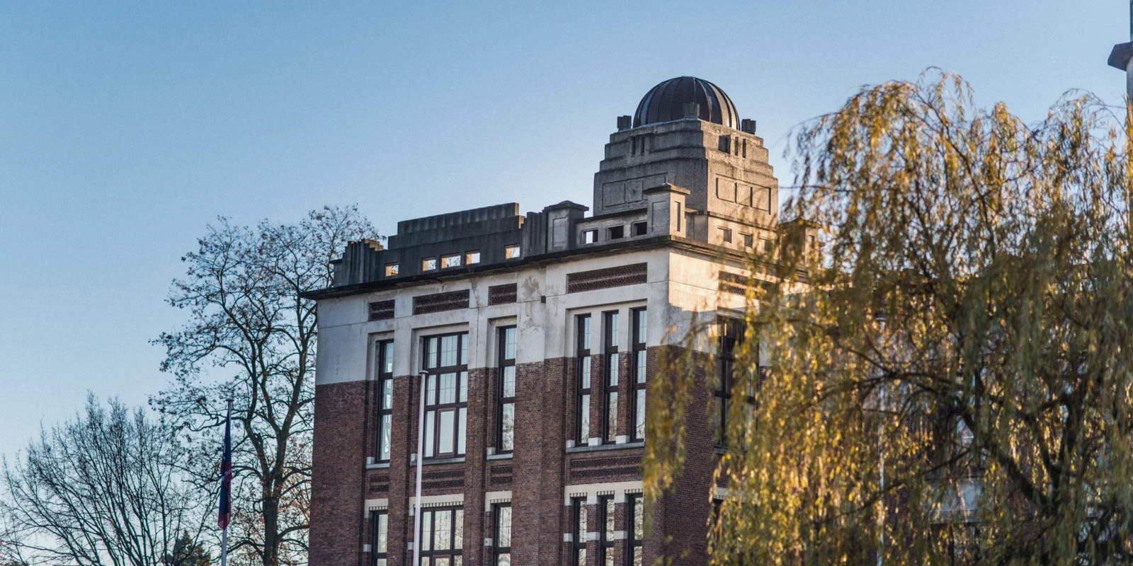 Urban building on a tree-lined street while traveling abroad.