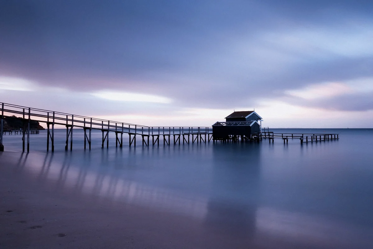 A quiet waterside pier under soft evening light during a road trip.