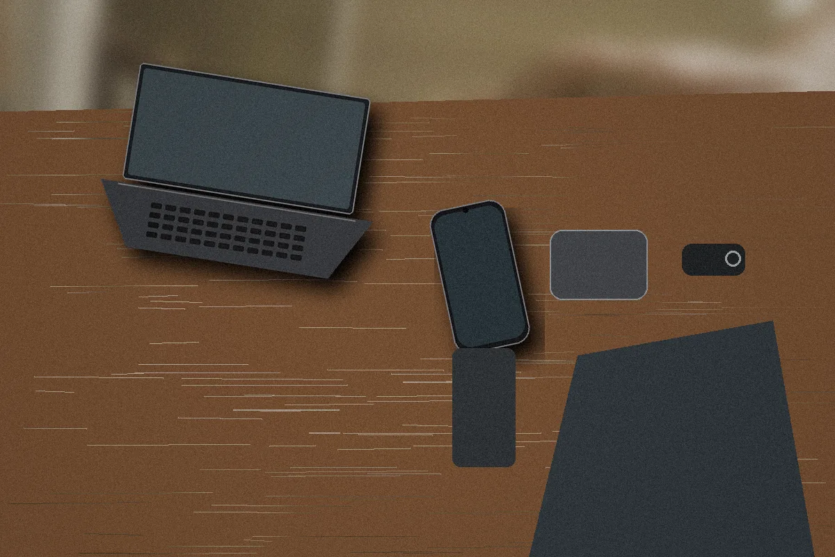 Travel laptop, phone, recorder, security key, and encrypted drive prepared before a reporting trip