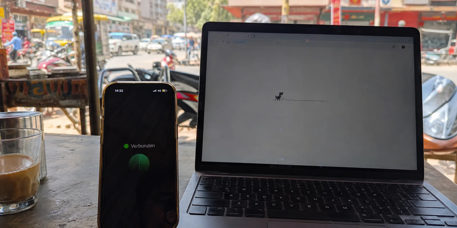 An einem Straßencafé in Lahore zeigt das VPN verbunden, während der Browser über die lokale SIM offline bleibt.